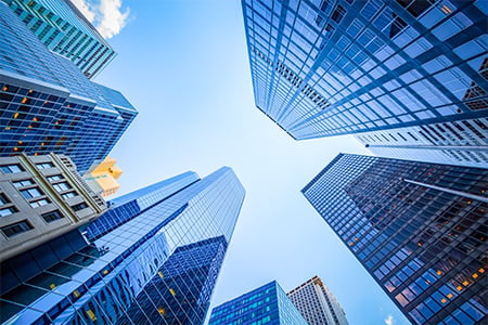 Modern glass office towers viewed from ground looking up