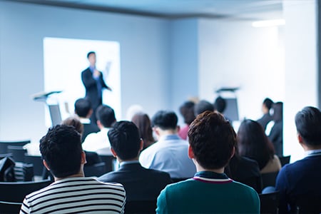 Audience watching business presentation in conference room